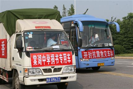 “棠湖中学捐书专用车”、“送一缕书香、献一片深情”的标语